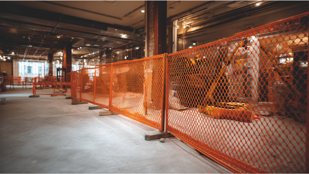 range mesh safety fence inside a commercial building under renovation.